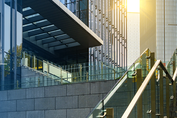 Exterior of a glass building  with semi circular graphics on one corner