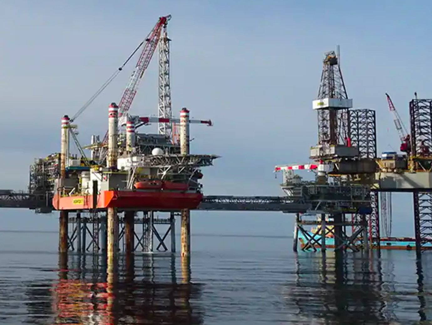 Two offshore oil rigs in operation at sea